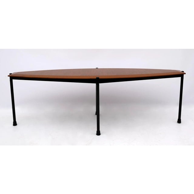 Detail table of the 1970s, mahogany veneered top and metal base, the shape remembers a surfboard.