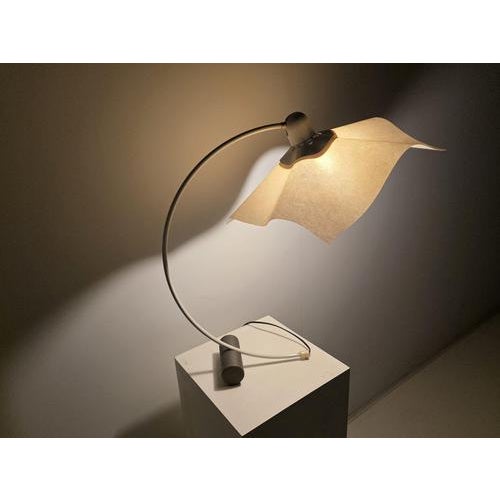 The Area Curvea table lamp, designed by Mario Bellini for Artemide in the 1970s, is a sculptural icon of Italian design....