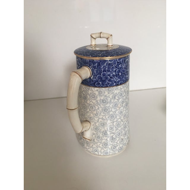 Royal Worcester hot chocolate pot, in porcelain, combining a decorative royal blue and gray flower design, on a cream...
