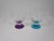 Set of four mid-century glass coupe's that are hand blown and have clear graduated tiers on a purple or peacock blue...