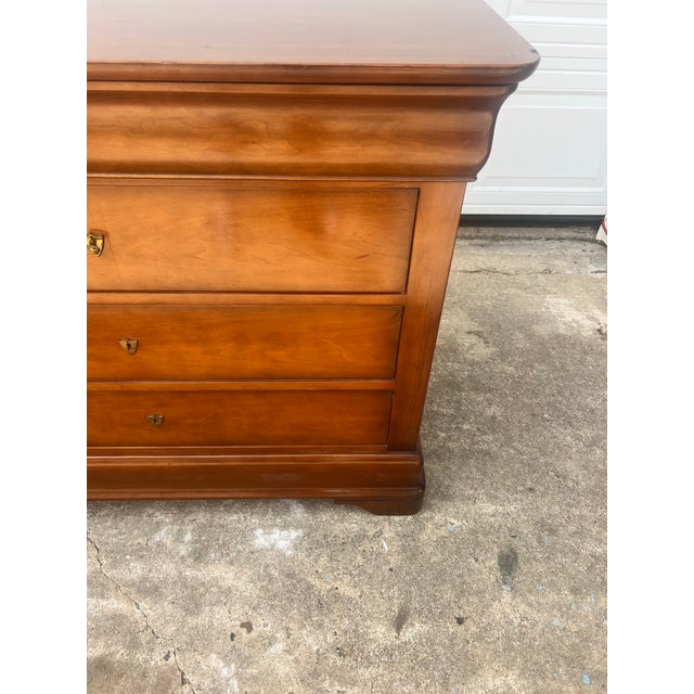 A handsome French Mid-Century Modern commode crafted in walnut, blending clean 1960s design with the timeless elegance of...