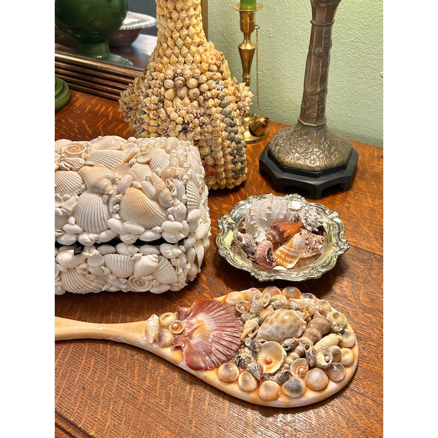 Bring a touch of vintage coastal elegance to your vanity or gallery wall with this charming mid-century seashell encrusted...