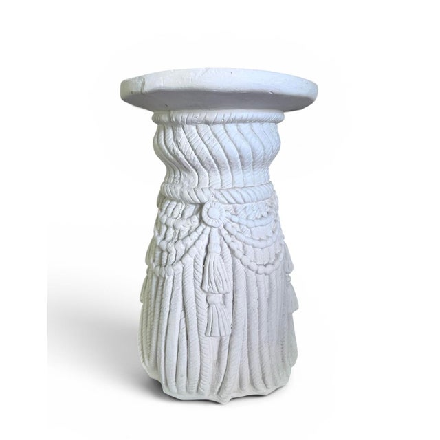 Side table or garden stool in the style of Dorothy Draper. Swag and tassel design with deep carved design. Hollywood...