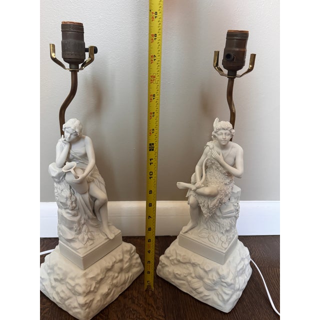 Beautiful complementary pair of vintage Arnart Creations porcelain table lamps, featuring finely detailed neoclassical...