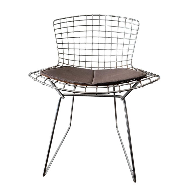 A set of 6 early Harry Bertoia Model 420 side chairs with original pads. Renowned for its airy, sculptural form, the chair...