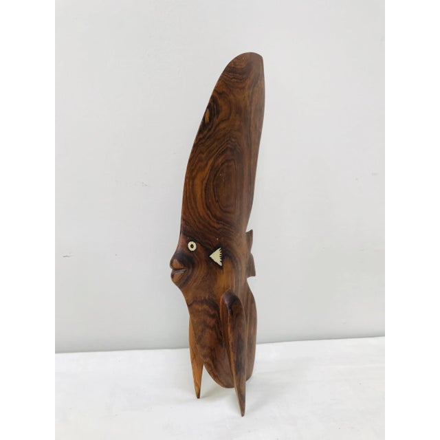 Groovy, large, 3-dimensional, carved teak angelfish with inlaid mother of pearl details. Very mid-century modern design of...