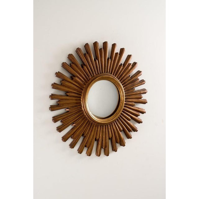 This vintage wall mirror shows the bold elegance of Mid-Century Modern and Hollywood Regency design. Crafted in Europe...