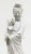 A wonderful Blanc de Chine figure of Guanyin standing with a flowing robe on a base of lily foliage. Wood base is...