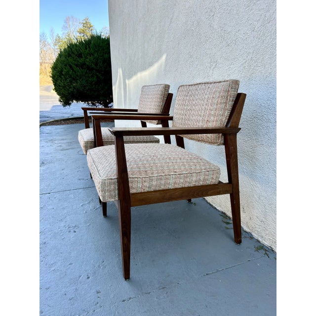 This rare pair of walnut lounge chairs were made in Grand Rapids in the 50’s and designed by Giacomo Buzzitta for Stow and...