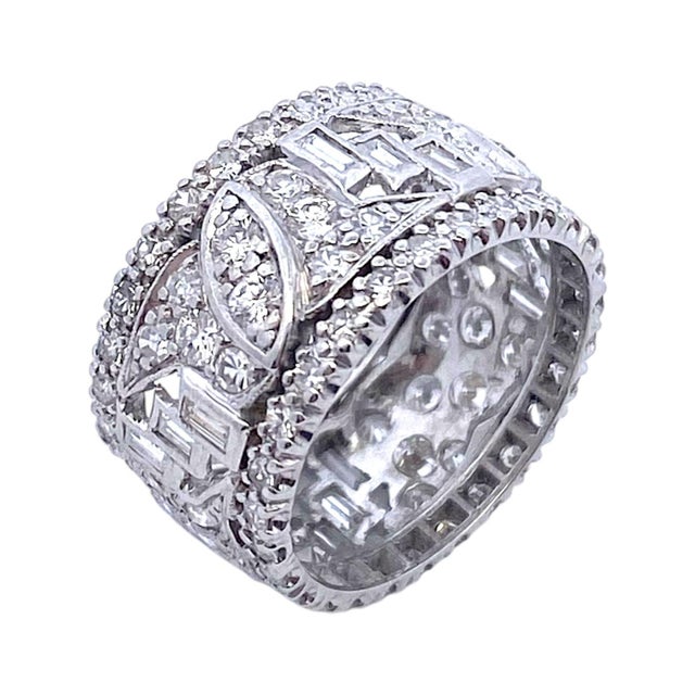 Vintage wide platinum eternity band featuring a dazzling array of white diamonds. The baguette and round cut diamonds are...