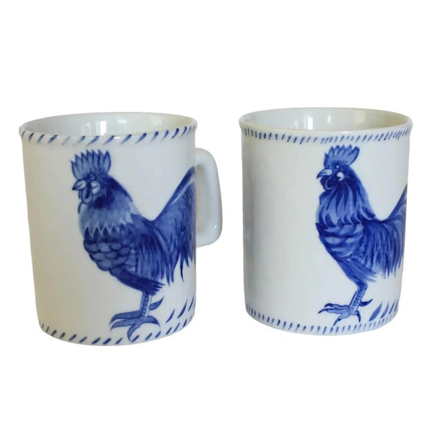 Pair of Cardinal Inc blue on white Rooster Coffee Mugs. Made in Thailand. Dated 1993. Some minor age wear. No chips.