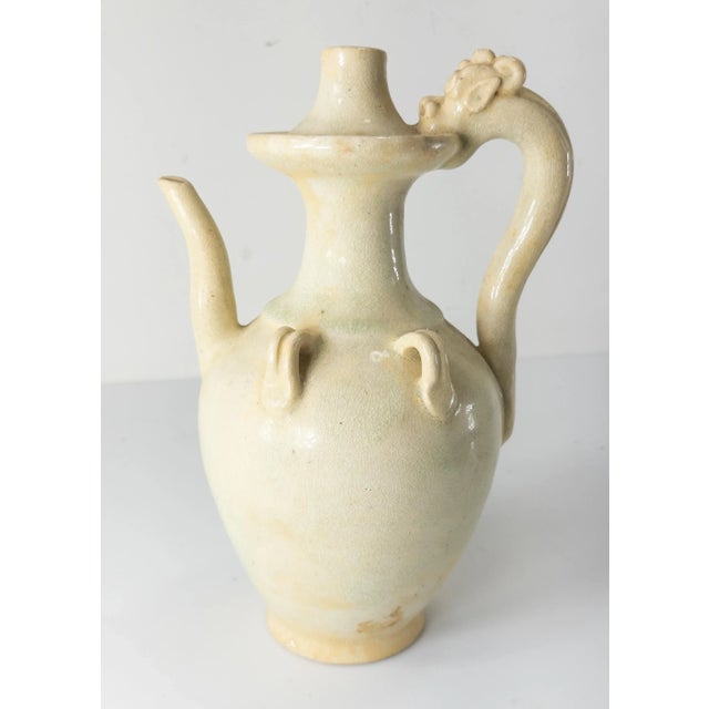 We are selling this Chinese Tang Dynasty style straw cream Qingbai style glazed ewer pitcher. This pitcher has a clear...