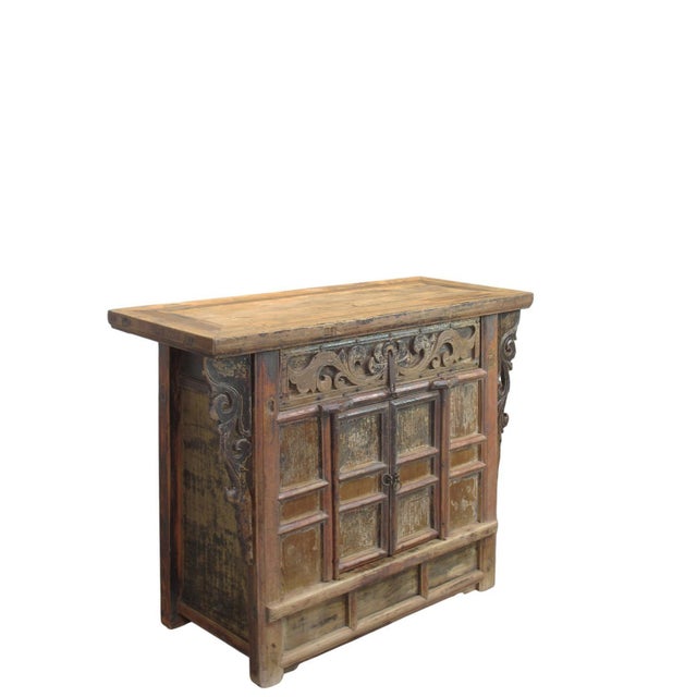 This antique cabinet is made from solid elm wood, showcasing a rich, warm grain and a beautifully aged patina. The piece...