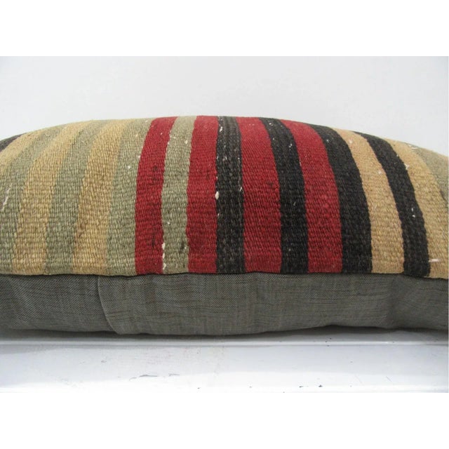 This is a pillow cover made from a vintage kilim rug. The piece was properly washed and ready to use. Pillow inserts not...
