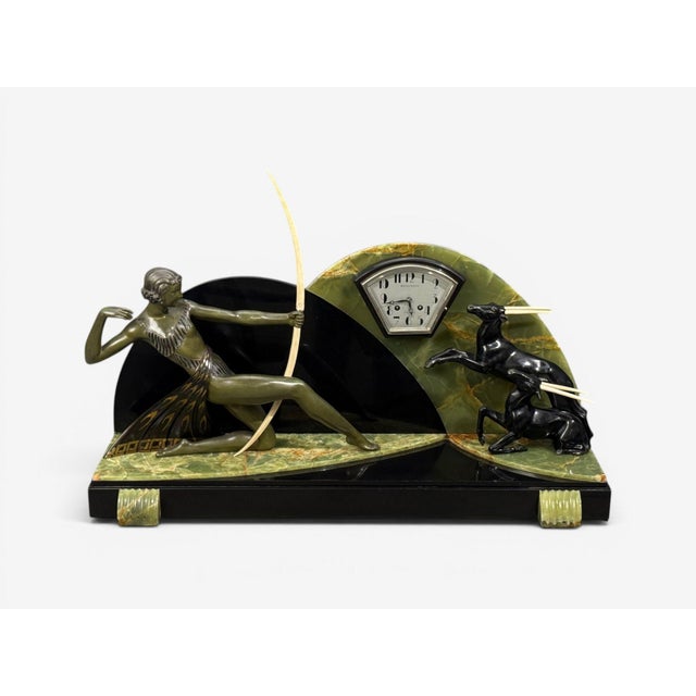 French Art Deco, Mantel Clock, Marble, Onyx, Gilt, France, 1930s A French deco mantel clock depicting "Diana the...