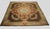 Handwoven in wool, this 12x12 antique oversized French Aubusson rug, dating to circa 1800, is a refined example of the...