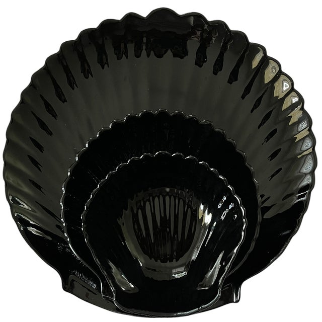 An iconic 18-piece vintage Arcoroc France "Coquillage" entertaining set in glossy black pressed glass, dating to the...