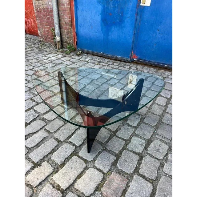 This black, space-age-style coffee table impresses with its futuristic design. The elegant, black frame with curved,...