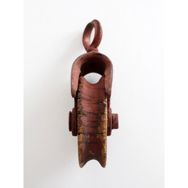 Antique F.E. Myers & Bro. cast iron and wood knot-passing hay pulley, an early piece of American barn equipment used in...