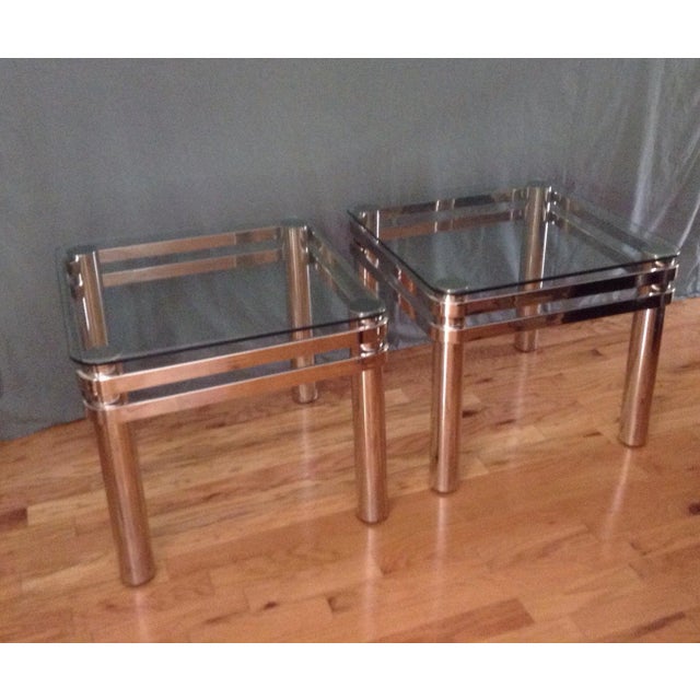 Pair of fabulous chrome and glass Design Institute of America DIA side tables. Late 70s early 80s. The glass sits above...