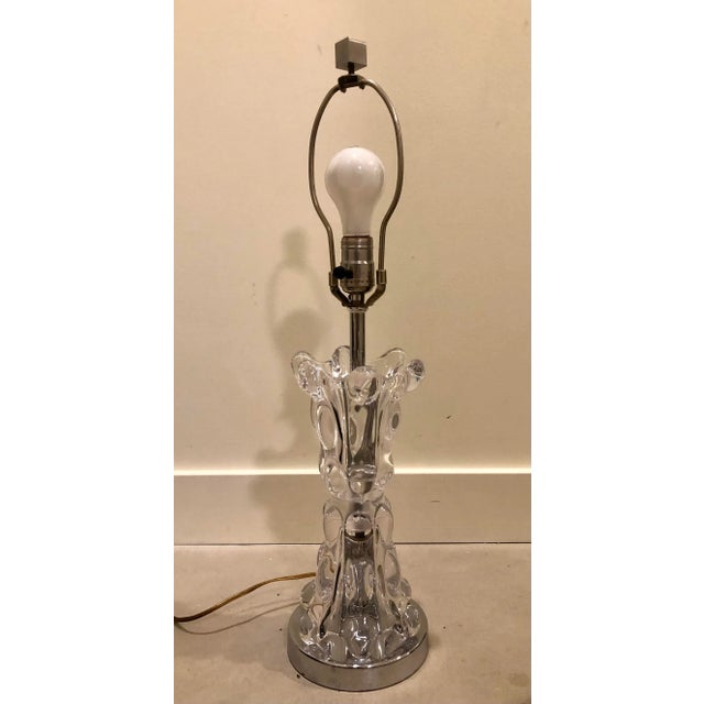 Chic sculptural glass lamp is great bedside or in any living space. The lead crystal bubble like texture adds a glam...