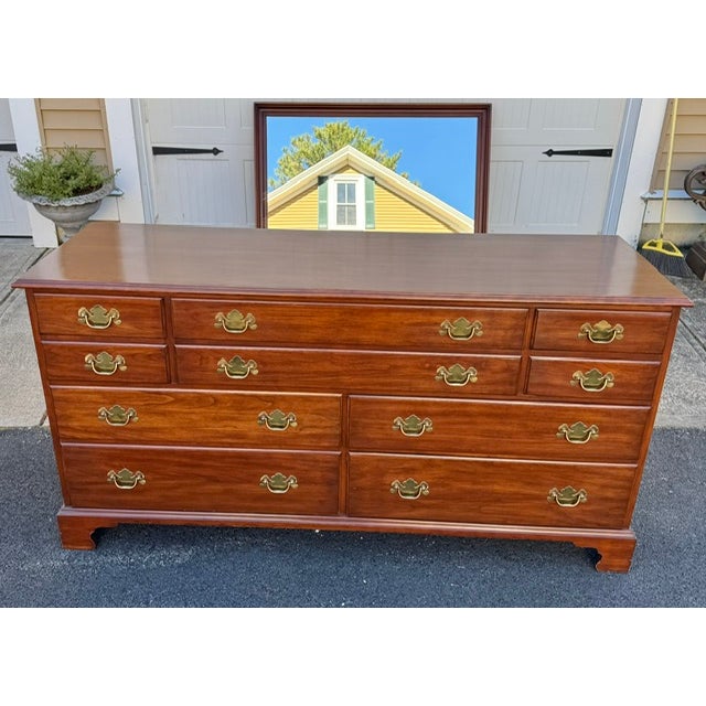 Beautiful 10 drawer solid black cherry double dresser with mirror by Henkel Harris. Dresser has its original brass drawer...