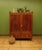 This is a handsome antique linen press which dates to the early 1800s. The linen press is made of mahogany and oak and is...