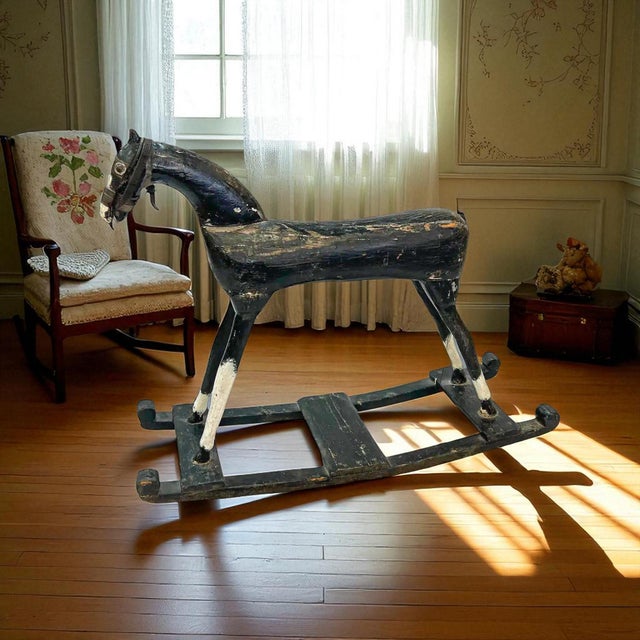 Discover a captivating piece of childhood history with this charming and rare early 19th-century folk art rocking horse....
