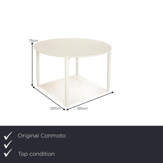 The Mito table by Conmoto is made of light gray wood and sits on four narrow legs. Its round shape and simple design...