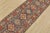 A tribal Caucasian Kazak runner hand-knotted with fine wool on a cotton foundation. This rug features a row of small...