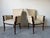 Beautiful pair of vintage Regency Revival armchairs featuring elegant carved wood frames, tall flared backs and cream...