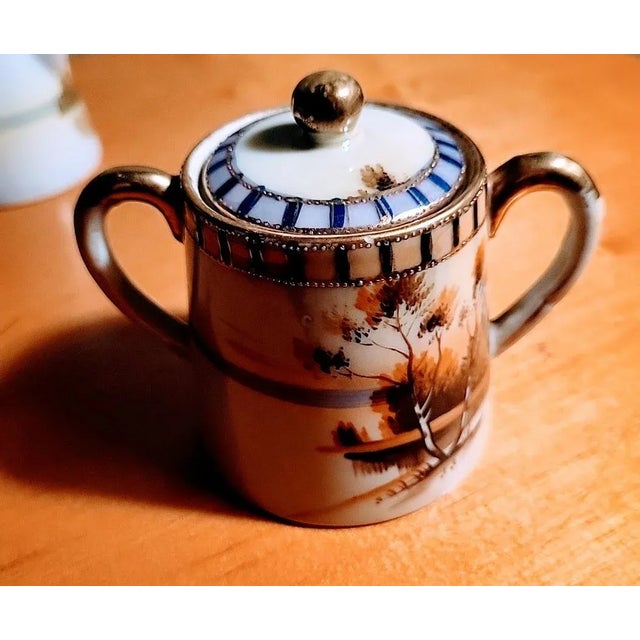 This set has a gorgeous traditional Japanese design, featuring a beautiful landscape. Handpainted and gold guilding detail...