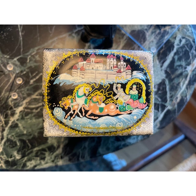 A lovely little treasure box that open on 3 different levels, painted and signed by an artist of the Palekh School of Art...