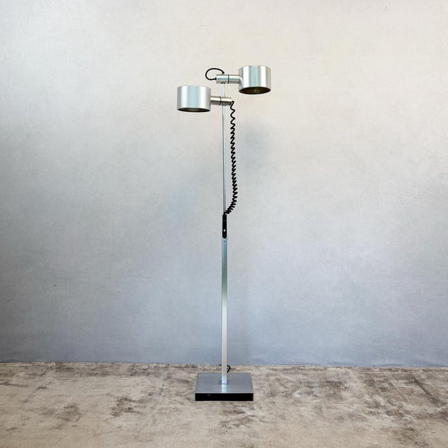 Constructed from satin chrome tubular steel, with a square-section adjustable riser column set into a square weighted base...