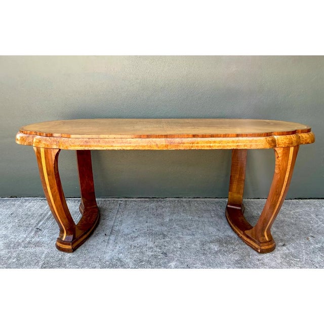 This vintage Art Deco center hall table is an elegant expression of streamlined 1930s design, its expansive oval top...