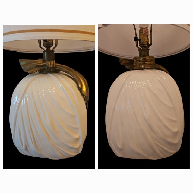 Gorgeous ceramic draped table lamps with brass ties. Classic and elegant. Lamps come with cylindrical 13" shades with gold...