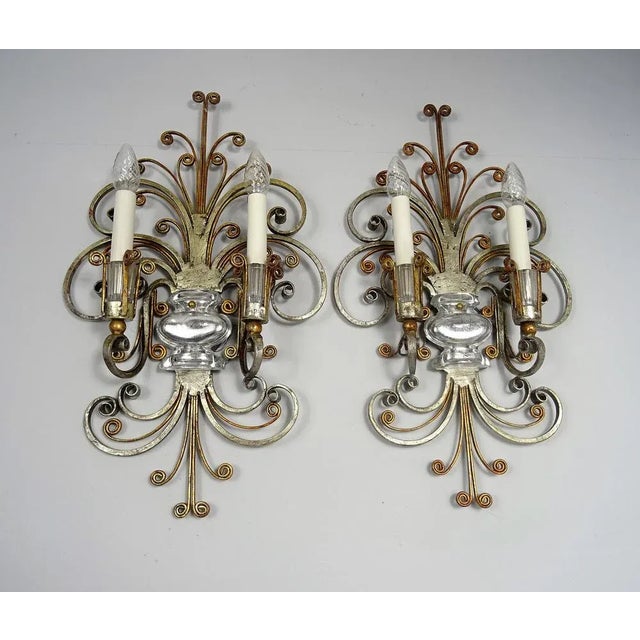 Pair of vintage wall lamps attributed to Maison Bagues. Silver and gold painted metal, mirrored glass inserts and glass...