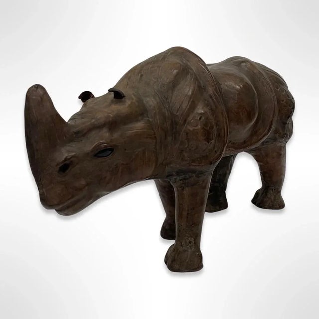 A high quality vintage Mid-Century leather-wrapped rhino sculpture that was crafted in the mid 20th century. The sculpture...