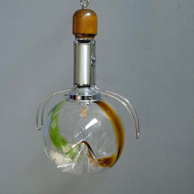 Beautiful pendant lamp, with a metal cup that goes to the ceiling, chain, wooden decoration and chromed steel tube....