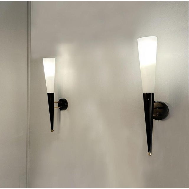 A striking pair of large, slender torch-form wall lights, crafted in Italy during the 1960s in the style of Stilnovo. Each...