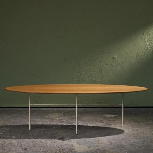 This oval coffee table from 1960s Germany combines a restrained industrial structure with the warmth of natural ash wood....