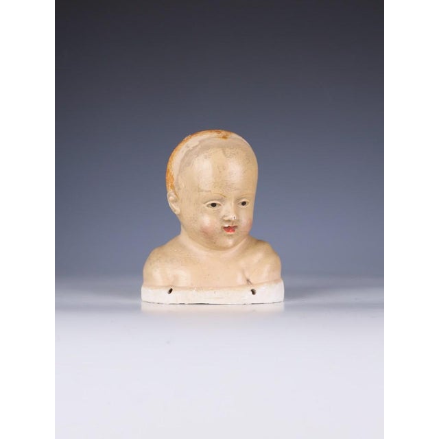 18th Century Tuscan Polychrome Stucco Head of the Infant Jesus (Bambino Gesù) A deeply evocative 18th-century Tuscan...