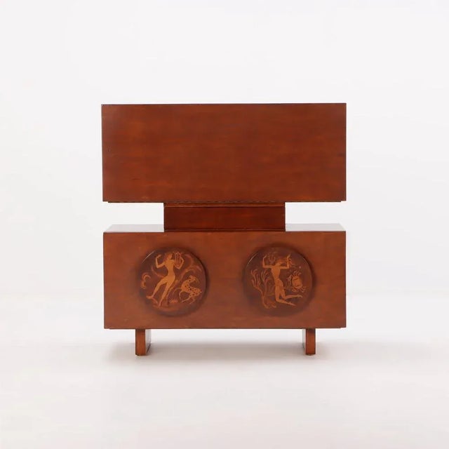 This masterpiece of cabinetmaking and wood inlay, by America's greatest artist working in this manner during the Art Deco...
