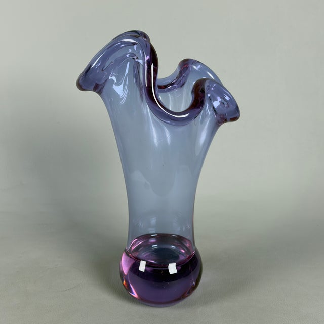 An imposing and luminous blown glass sculpture that perfectly embodies the vivacity and elegance of 1970s Italian design....