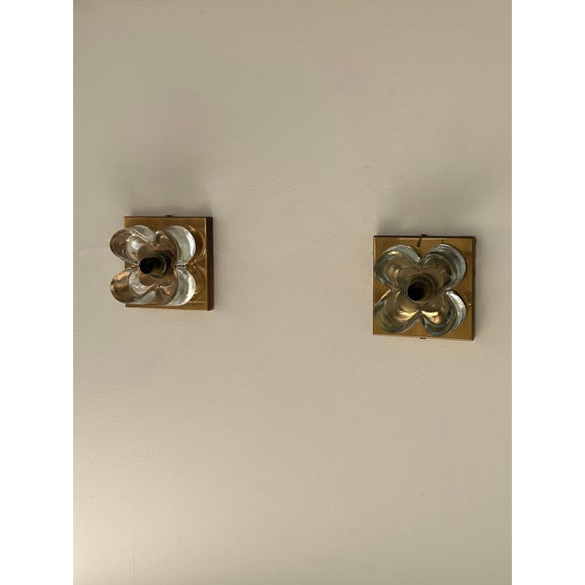 Pair of brass and glass wall sconces produced in Germany in the 1970s by Sische. Floral motif, play of light, slight...