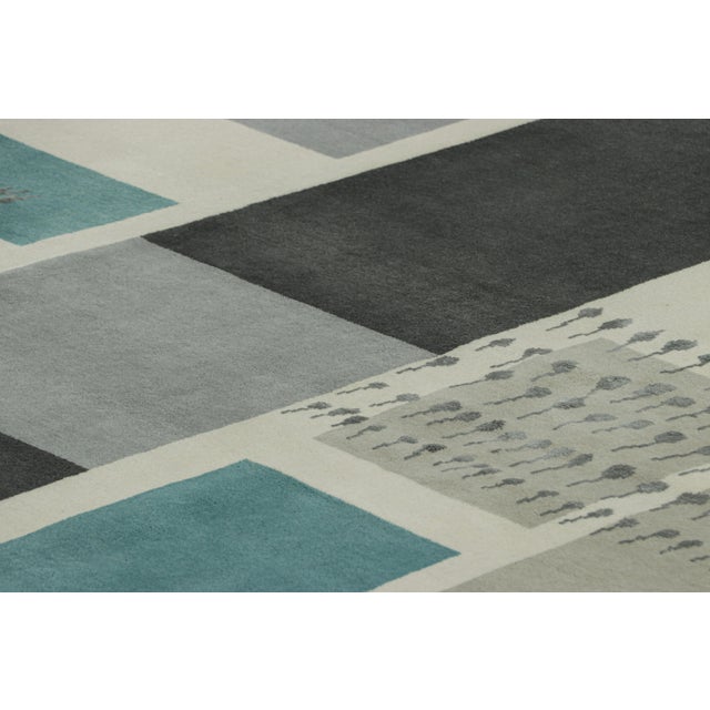 Hand-knotted in a luxurious blend of wool and silk, this 9x12 modern rug is a sophisticated new addition to the Mid-...