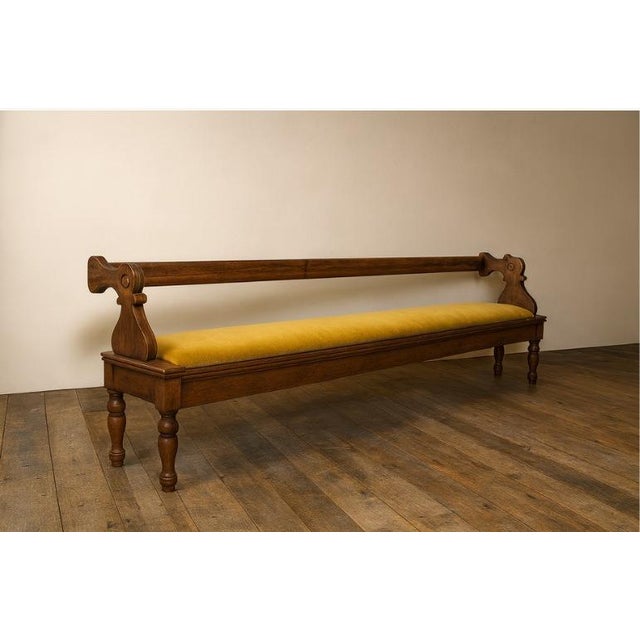 Exceptional antique reversible wood bench with a velvet-upholstered seat, dating to the late 1800s. At nine feet long, it...