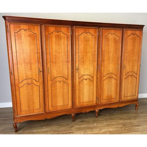 This impressive vintage French Louis wardrobe features a grand scale, elegant panelled doors, and beautifully shaped...