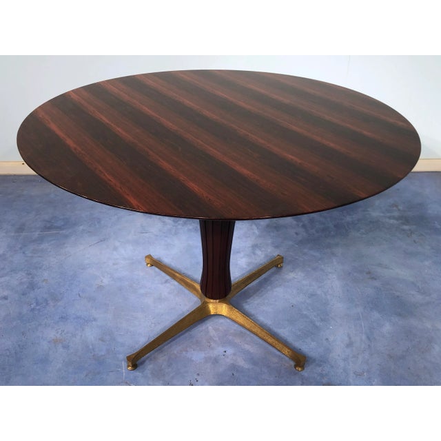 This Italian midcentury rosewood table attributed to Paolo Buffa 1950, is an example of pure Italian design on the period....