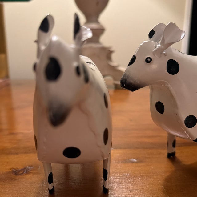 Cute Cows, made of metal and painted white with black polka dots. They eat little and don’t smell like most cows.